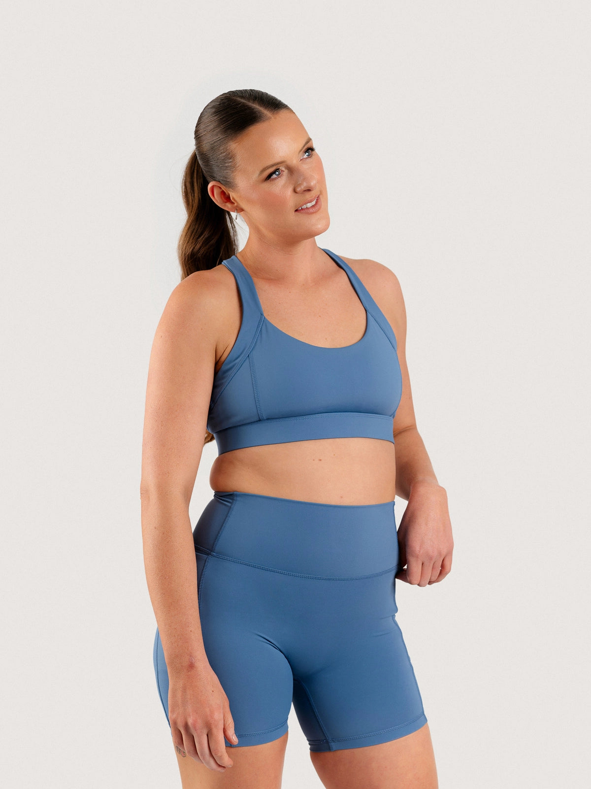 Front view of the Aella Storm Hybrid Shorts and Sports Bra
in Coastline.